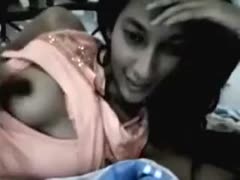 An Indian beauty is seen flaunting her breasts over a webcam.